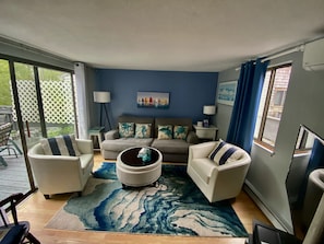 Relax in this stylish living room with a large sofa, armchairs, and a coffee table.