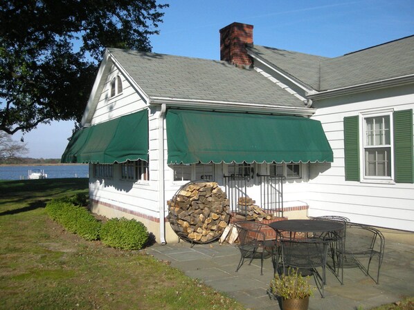 A white house with green shutters and a chimney, a stone stack, and outdoor furniture. - Waterfront Home On 3 Acres. Fish,crab, & kayak from the pier + great sunsets! (Chester)