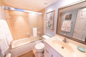 A bathroom with a bathtub, toilet, and sink. - Beachfront 2BR Condo w/ Balcony & Heated Pool, Unit 224 (Satellite Beach)