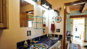 A bathroom with two sinks, a mirror, and a towel rack.
