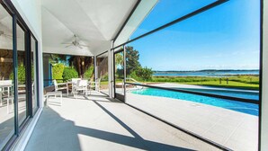 A modern outdoor area with a pool, clear skies, and a view of the landscape. - SWISS 06 - Lake Sumner (Clermont)