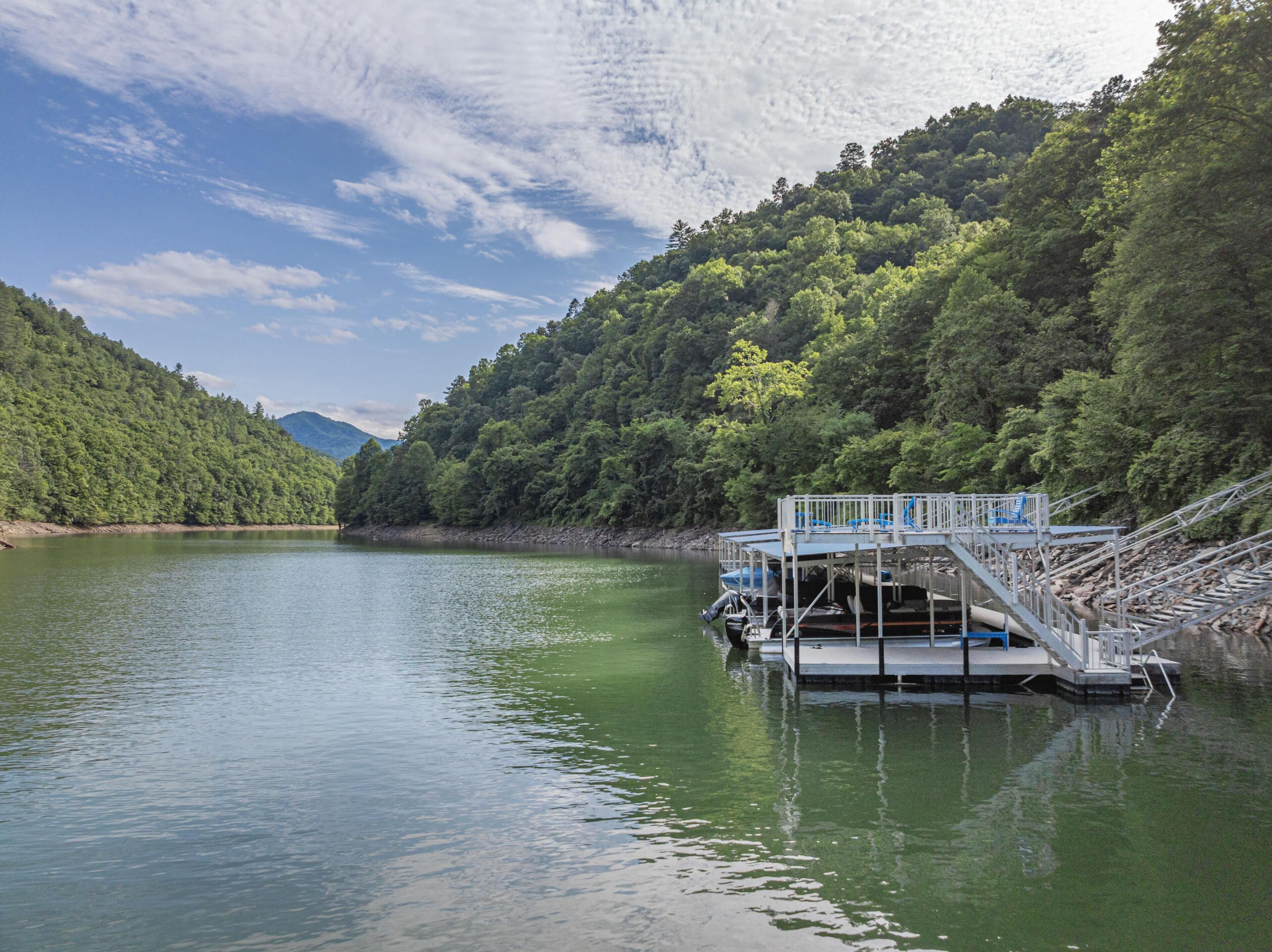 A lake with a dock and a viewing platform.
