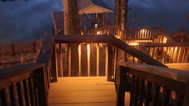 A wooden deck leading to a gazebo by a calm lake at dusk. - Wonderful home with dock on Tellico Lake (Loudon)
