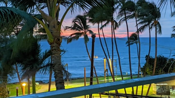 A view of a beach with palm trees and a sunset. - Unobstructed ocean view 2Br/2Ba - upscale at a budget price (Kihei)