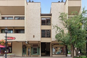 A multi-story building with a central staircase, a visible entrance, and a storefront on the ground floor. - 100 ft. to Gondola!! Balcony, Fireplace, Views, Parking!! Heart of Lionshead!! (Vail)