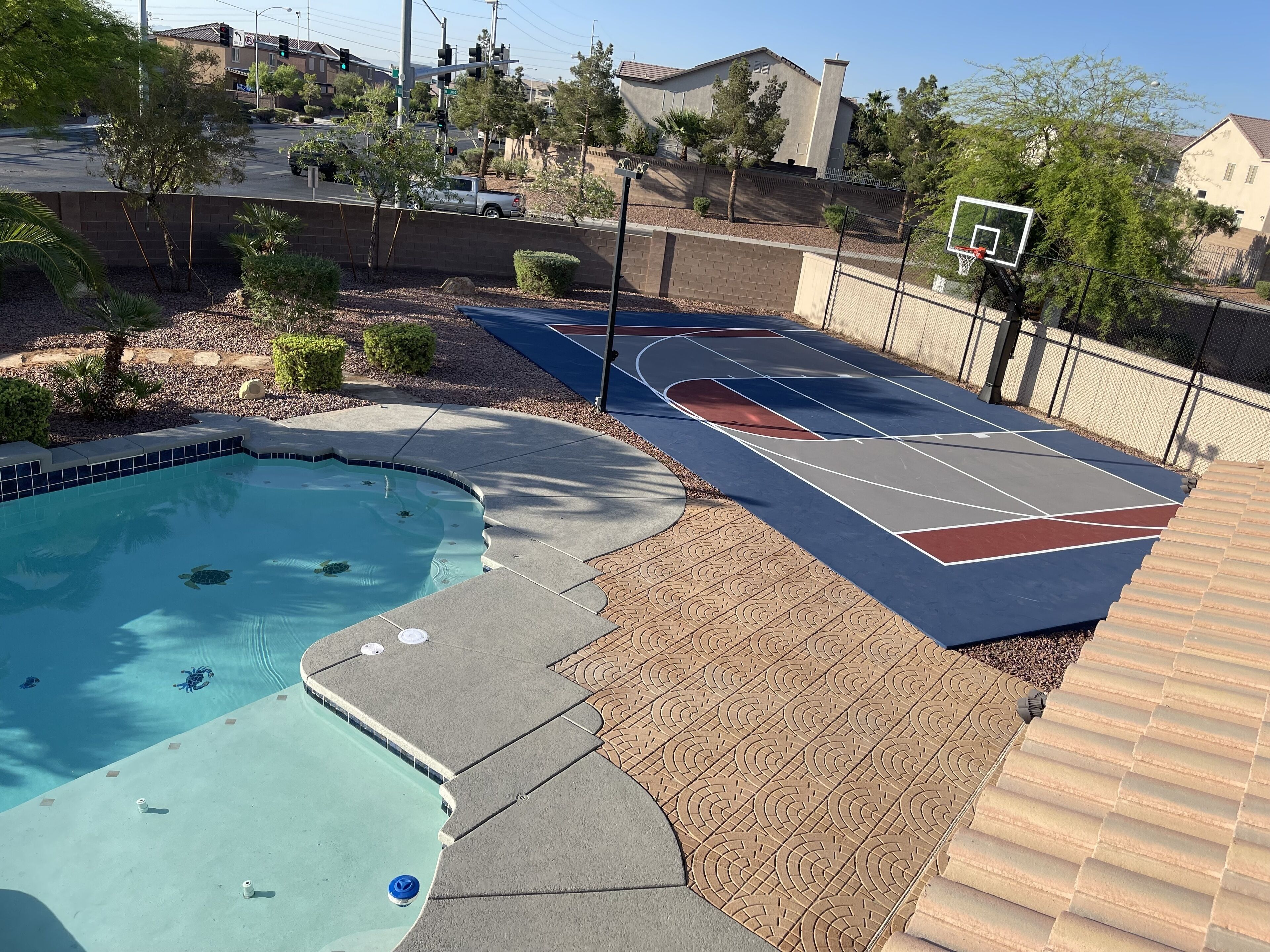 Una piscina con un campo da basket e un canestro.