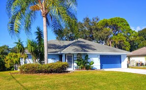 A single-story house with a grey roof, a front porch, and a garage. - Relax in our PRIVATE Pool at Water View Villa (Venice)