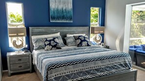 A bedroom with a bed, two bedside tables, a nightstand, a window, and a painting on the wall. - Relax in our PRIVATE Pool at Water View Villa (Venice)