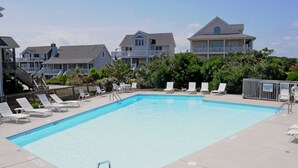 A rectangular swimming pool with lounge chairs and a staircase leading to a building. - Boca North - Ocean View 3BR Home & Community Pool!!! (North Topsail Beach)