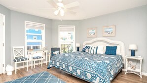 A bedroom with a bed, a desk, a chair, a window, and a ceiling fan. - Boca North - Ocean View 3BR Home & Community Pool!!! (North Topsail Beach)