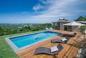 Relax by the pool, surrounded by lush views and comfortable lounge chairs.