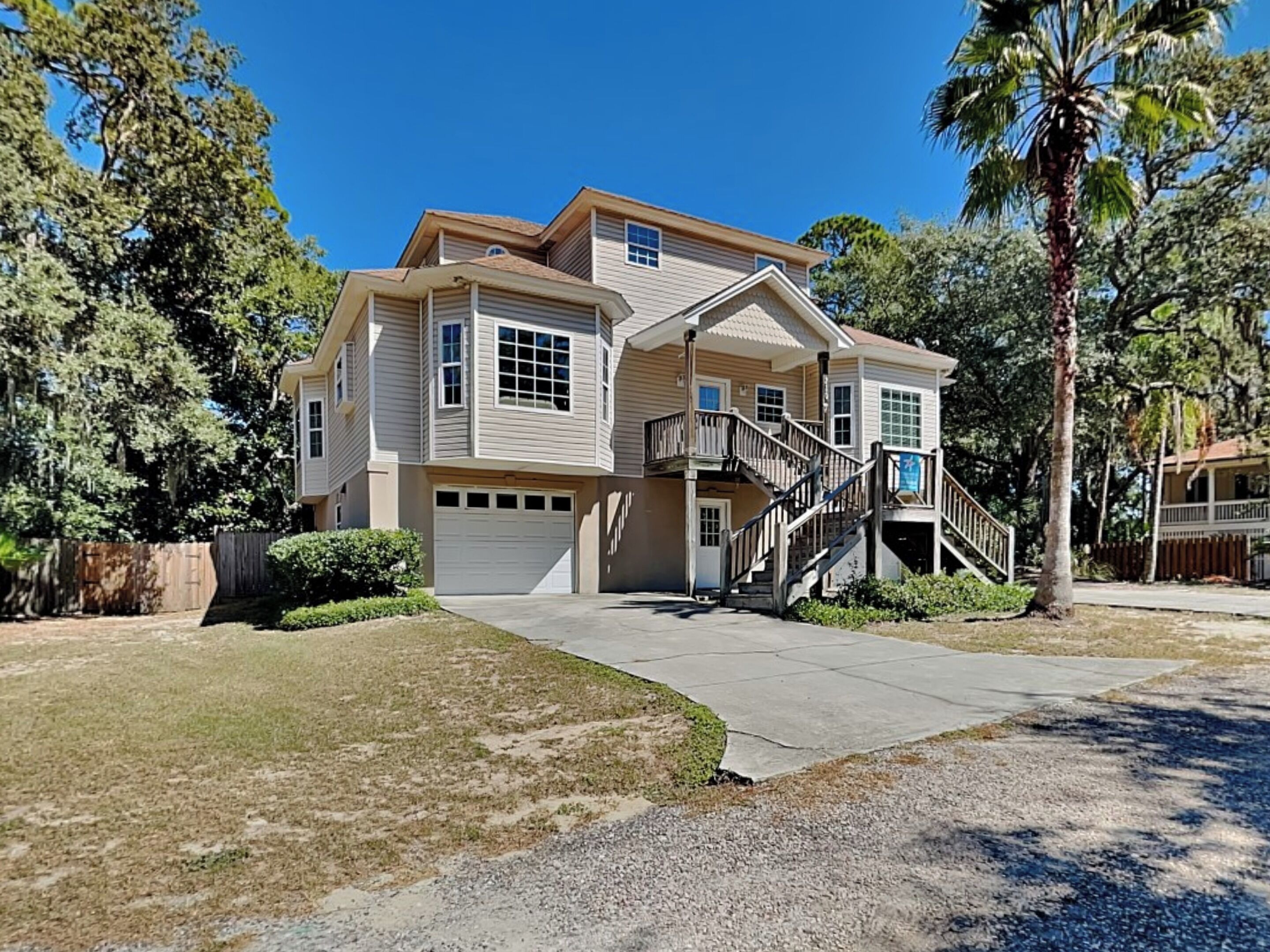 A two-story house with a front porch, a staircase, and a garage.