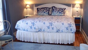 A bedroom with a bed, two bedside tables, a chair, and a lamp. - Downtown St. Joe! Walk to BEACH & EVERYTHING! Clean & Comfortable!  Best Value! (St. Joseph)