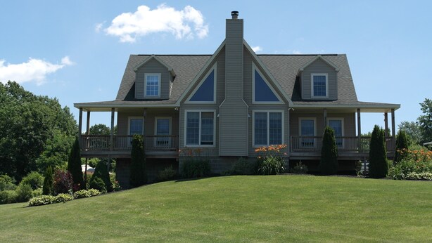 A large, two-story house with a symmetrical facade, a central chimney, and a covered porch on each side. - Large Finger Lakes Getaway - 5 BR with Bath Access! (Naples)