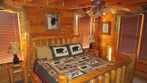 A log cabin bedroom with a wooden bed, a ceiling fan, and wooden walls. - Bears Abound-- a Dog-friendly, Log Cabin With Breathtaking Views (Sevierville)