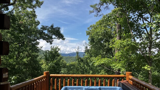 A wooden deck with a hot tub overlooking a forested mountain landscape. - Bears Abound-- a Dog-friendly, Log Cabin With Breathtaking Views (Sevierville)