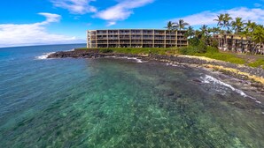 A hotel with multiple floors, a beachside location, and clear waters. - Poipu Oceanfront, 10 steps to ocean (Poipu)
