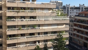 A multi-story building with balconies, some with plants. - Luxury Apartment in Great Location. Come and be Parisian for a week! (Boulogne-Billancourt)