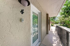 A building exterior with a door, a number '4' sign, and a power outlet.