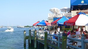 A waterfront bar with outdoor seating and a view of the water. - Ditch Plains - Walk to Ocean Beach - New Kitchen, Bath, & Bedrooms (Montauk)