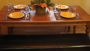A dining table set for two with a view of a forest through a window. - Wonderful Winter Escape with Mountain views in Forest-like setting (Burney)
