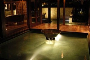 Experience the serene ambiance of this stylish space, featuring a striking metallic centerpiece and sleek wooden flooring.