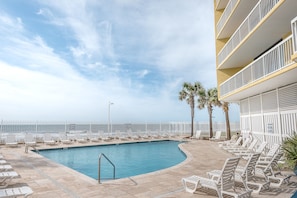 A pool area with lounge chairs and a view of the ocean. - COV 220 - Elegant Oceanfront Villa - Unbeatable Views - 2 Pools (Folly Beach)