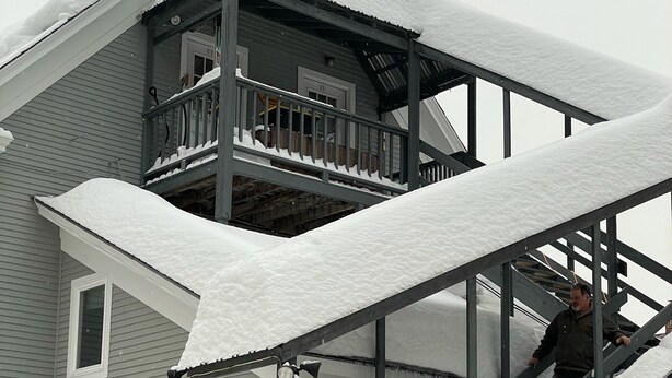 A multi-level wooden structure with a balcony, surrounded by snow. - Okemo Mt. Family Affordable 1st floor, village shuttle, walk to town, Dogs OK  (Ludlow)