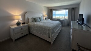 A hotel room with a bed, bedside tables, a desk, and a TV. - 4th Floor Crescent Beach Condo Offering Full Unobstructed Gulf Views.

  (Siesta Key)