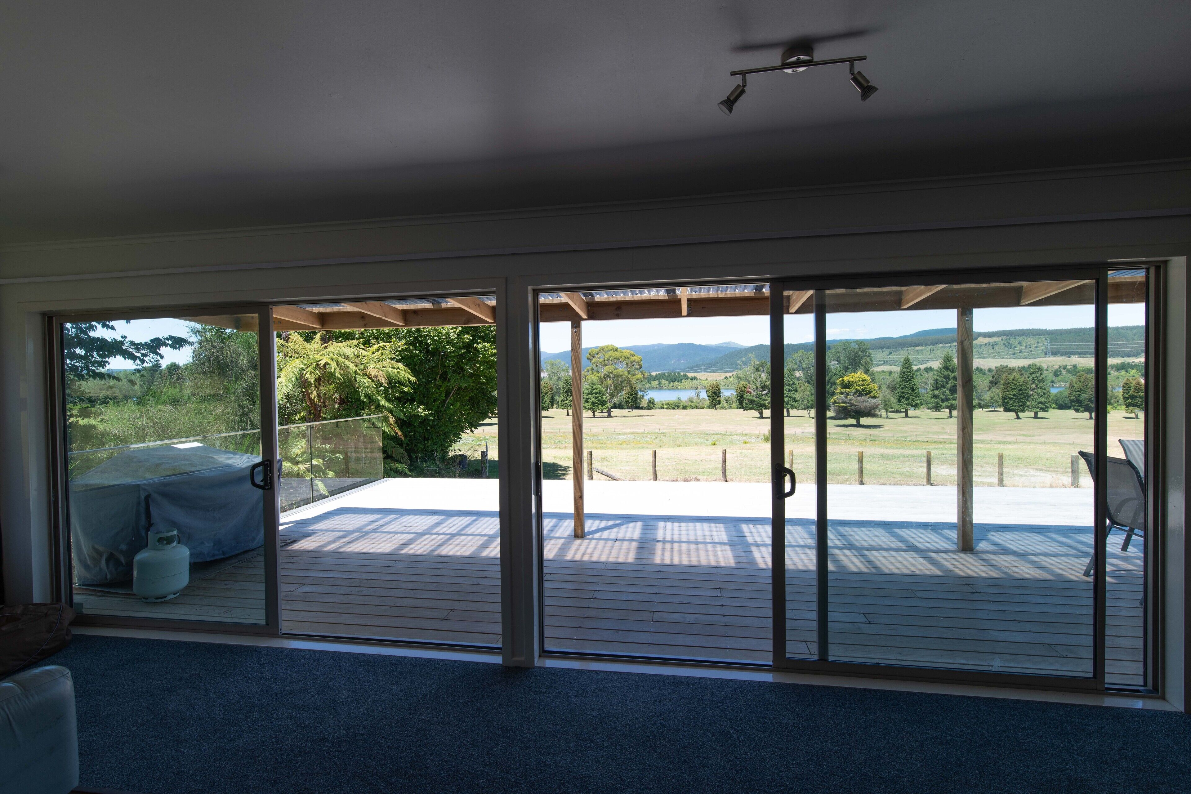 A spacious room with large sliding glass doors leading to an outdoor deck.