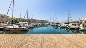 A marina with multiple boats docked along a wooden pier. - 🌴 Sunny 3-Bedroom Marina Apartment | Sea Views | Secure Parking | Beach Walk (Mauguio)