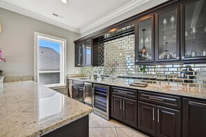 Modern kitchen with sleek cabinetry, large island, and appliances.