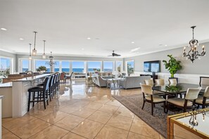Enjoy meals in this well-lit kitchen with ocean views, a large island, and ample counter space.