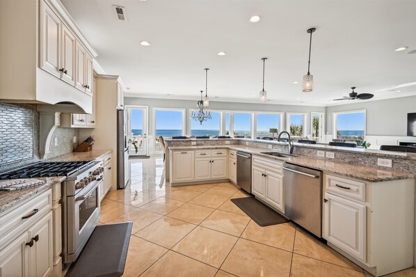 Enjoy cooking with a central island and ample counter space, offering ocean views.