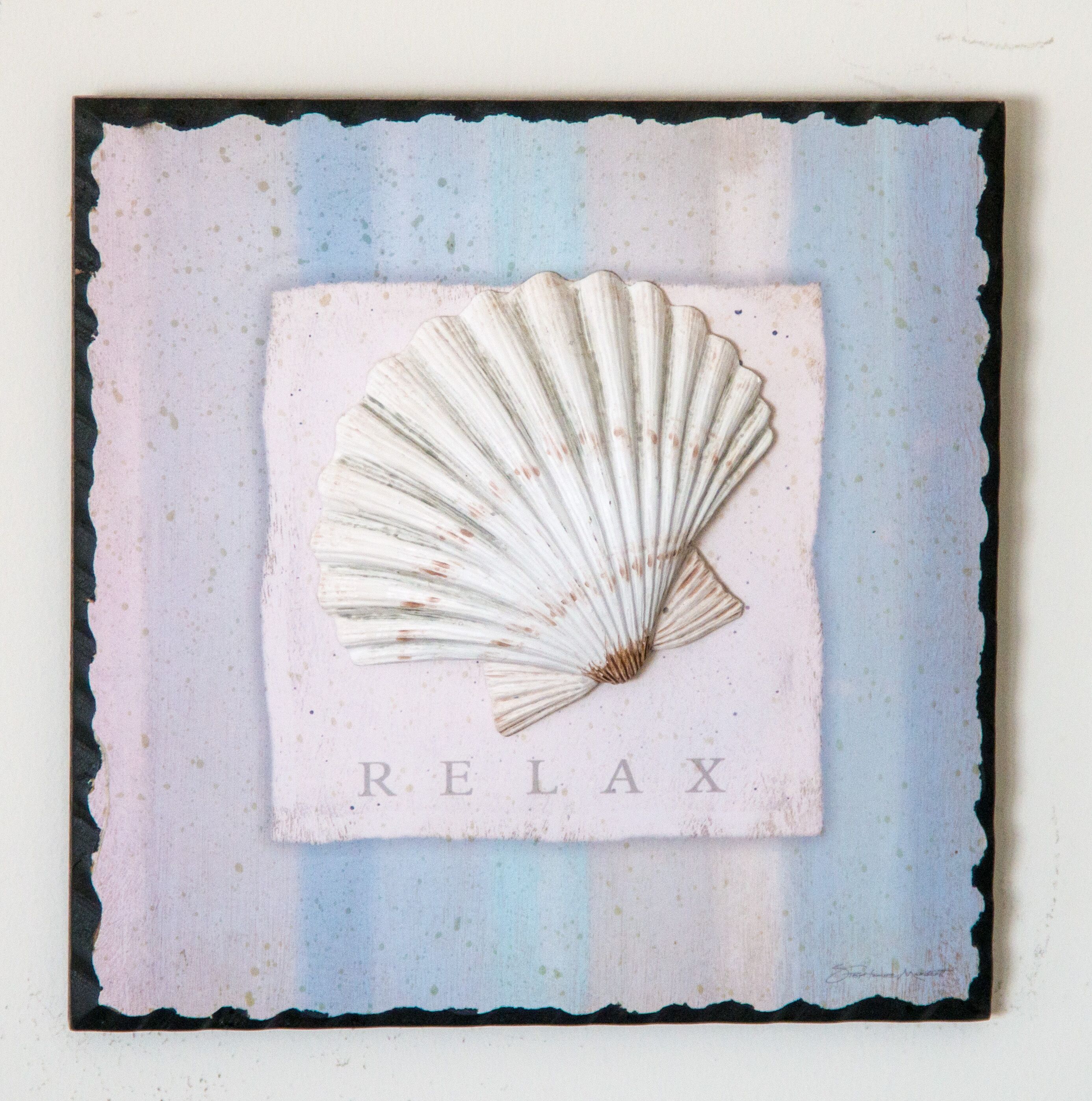 A framed artwork with a scallop shell and the word "RELAX" on a textured background.