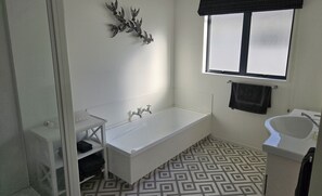 Bathtub, hair dryer, towels, soap