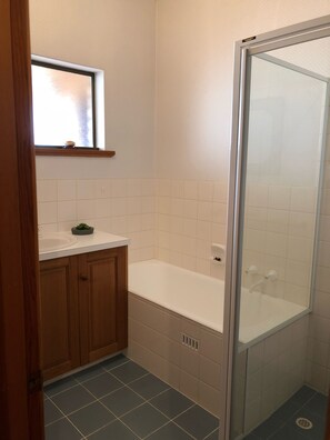 Bathtub, hair dryer, towels, soap