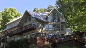 A large, multi-story house with a prominent balcony and a staircase leading to the upper levels. - Czarnecky Home - Waterfront Home in Deerfield Resort, Dock, Hot Tub, Firepit (La Follette)