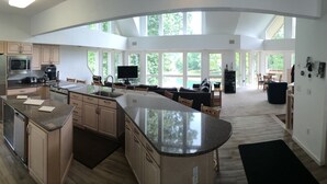 A spacious kitchen with a large island, built-in appliances, and a view of the outdoors. - Czarnecky Home - Waterfront Home in Deerfield Resort, Dock, Hot Tub, Firepit (La Follette)