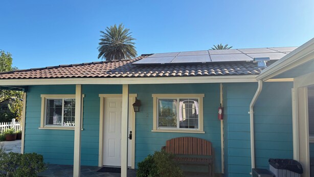 A single-story house with a teal exterior, a tiled roof, and a front porch with a bench. - Private Guest house close to Disneyland & Little Saigon Mall (Santa Ana)