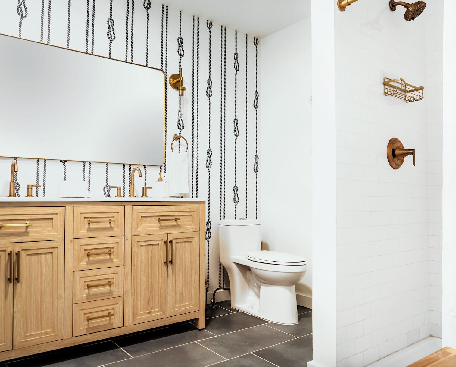 A bathroom with a wooden vanity, a white toilet, and a shower area.