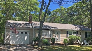 A single-story house with a garage, a front porch, and a small lawn. - Quiet 3BR Ranch - Little Dog Friendly! (2033) (Harwich)