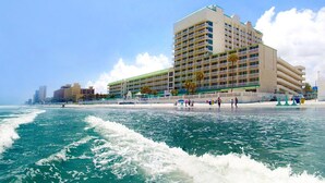 A beachfront hotel with multiple balconies, a pool area, and a beach view. - Beautiful 9th floor OceanView Studio Condo  - Pool is OPEN! (Daytona Beach)