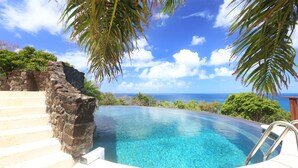 A infinity pool with clear blue water, stone steps, and a view of the ocean. - Ultimate Caribbean Getaway: 3 beaches, Cook, Housekeeper & Valet, 24x7 Concierge (Gros Islet)