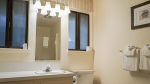 A bathroom with a sink, mirror, toilet, and towel rack. - Emerald Room At Forest House (Pre-packed Breakfast Inc., 1mile from Mt Rainier) (Ashford)