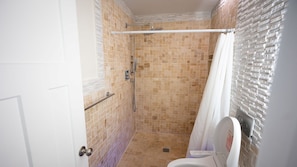 A bathroom with a shower, a toilet, and a towel rack. - Paradise Found - Updated Classic 3 BR Home - Direct Oceanfront! (North Topsail Beach)