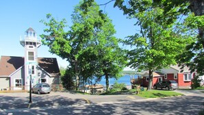 A coastal town with a lighthouse, a marina, and residential houses.