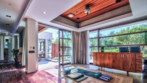 A spacious room with large windows, a wooden ceiling, and a modern design. - Private Custom Modern 10,000 sq. Ft. Estate -- Nestled on 15 Acres (Temecula)