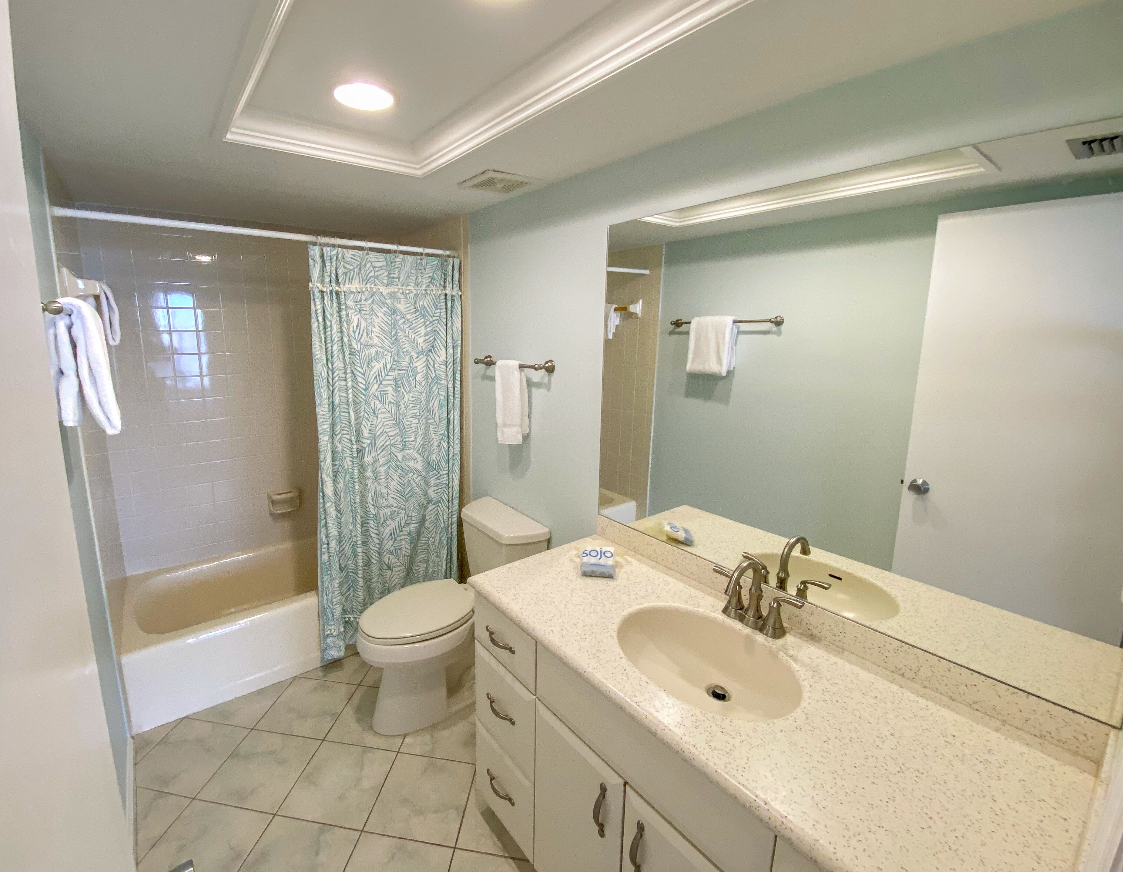 A bathroom with a bathtub, toilet, and sink.