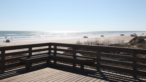 A wooden deck overlooking a beach with a clear sky. - Quiet, Big, Bright and Beautiful!  Perfect Beach House for Family and Friends (Port Aransas)